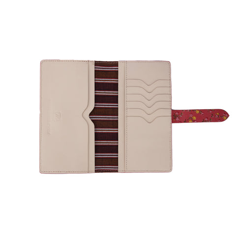 A red leather wallet with a floral pattern and a striped cotton lining visible from inside