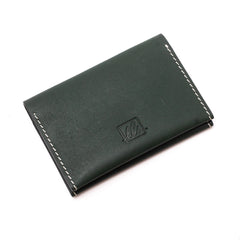 A closed dark green  bi-fold credit card holder with visible stitching and a embossed logo on the front of the leather story