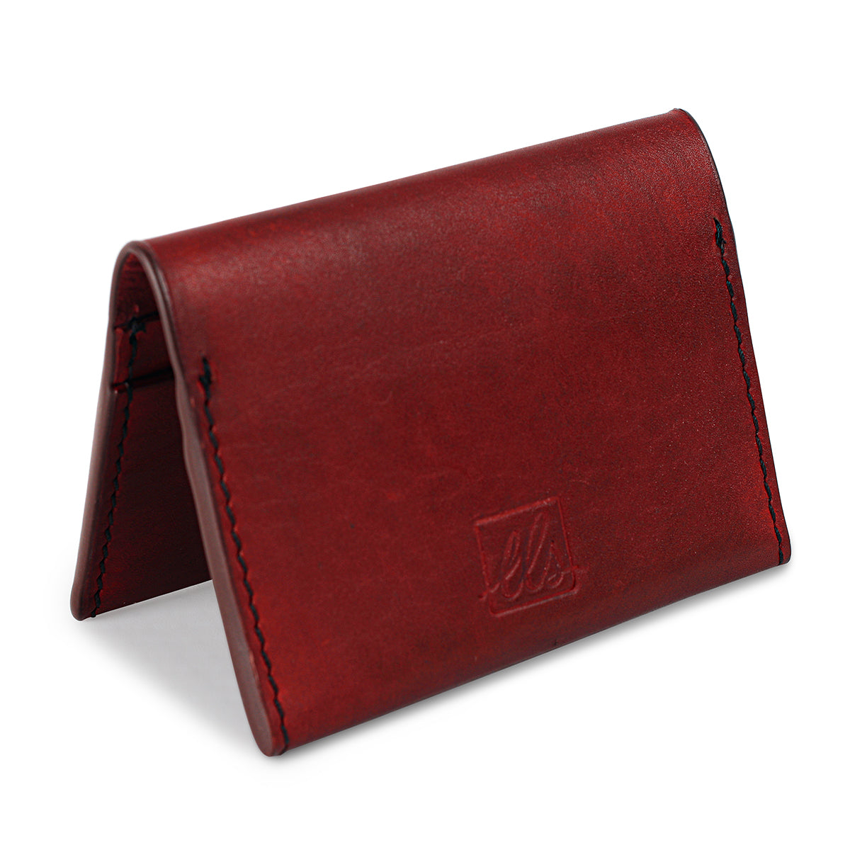 A  closed red bi-fold credit card holder with visible stitching and a embossed logo on the front of the leather story