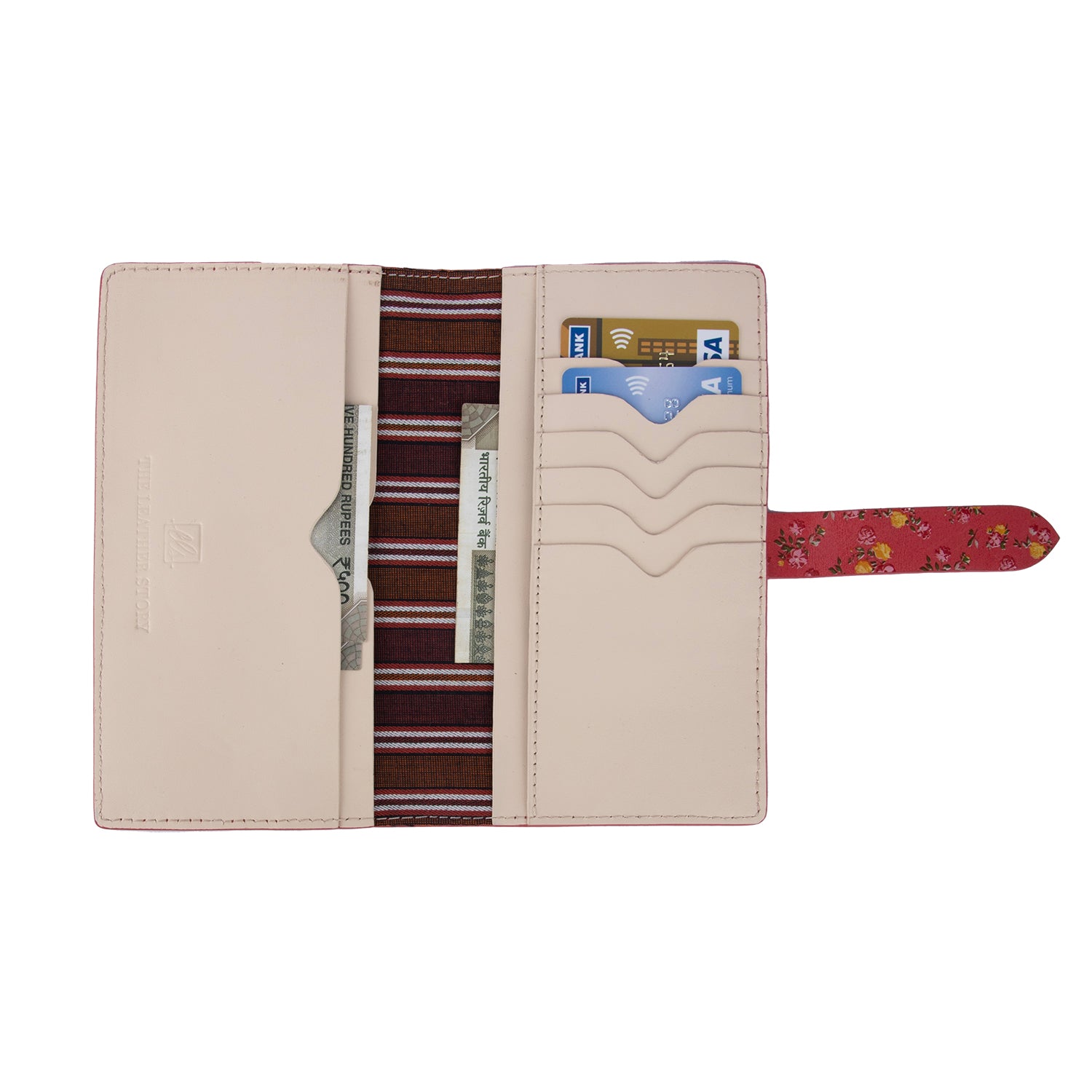 A red leather wallet with a floral pattern and a striped cotton lining visible from the inside with showing the usablity of the wallet 