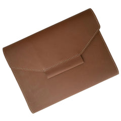 A tan brown leather notebook  organiser with a pen slider, closed with a regular book binding. The notebook appears to have a solid, smooth finish.