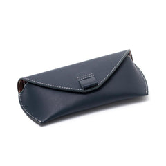 A  neavy blue leather sunglass case with a cotton-lined interior .